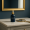 Luxurious serum bottle with gold accents and a mirror on a marble vanity